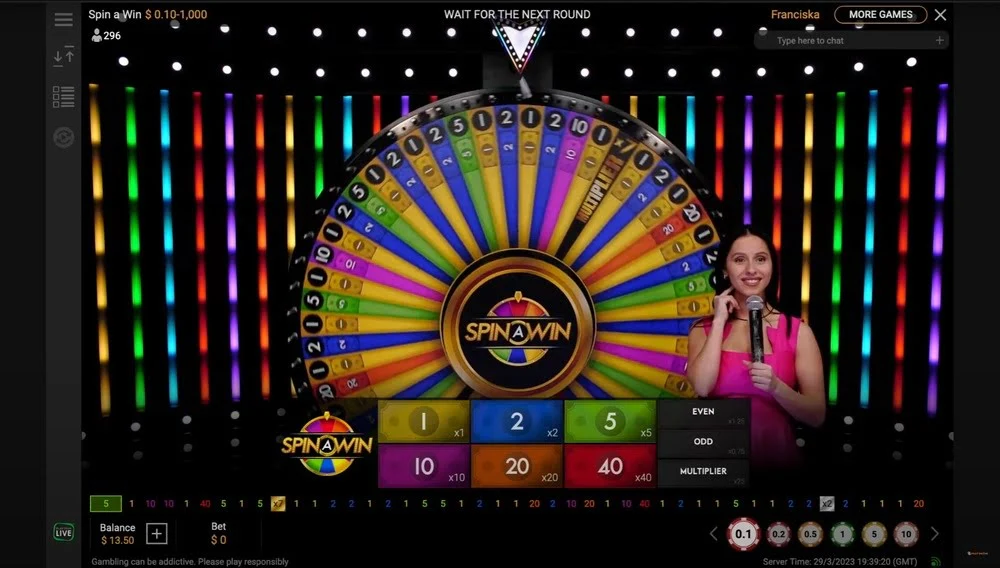 The game takes place in an impressive studio, where the host spins a giant wheel